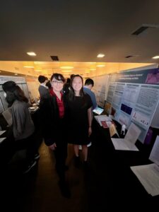 Dr. Criley (left) and Naomi Kao (right) stand beside Naomi's project on hand hygiene training for elementary school students.