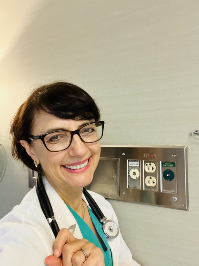 Dr. Jasminka Criley standing in a hospital setting, promoting hygiene and patient safety.