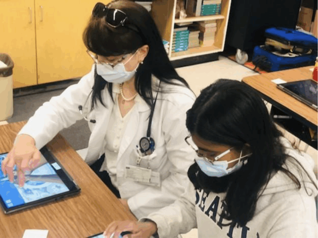 Screenshot 2025-10-15 at 15052 PM - Indelible Learning Dr. Criley and a student are playing Bubble Beats Trainer side by side in a classroom setting.